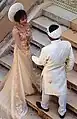 A bride and a groom wearing khăn vấn on their wedding.