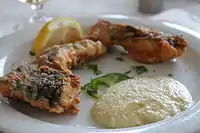 Salted cod with garlic sauce, a traditional Greek dish for the day of the Annunciation, served at a Greek restaurant