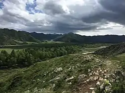 The valley just north of the village with fields and the road to the village.