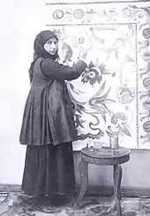 A woman poses in front of a painting