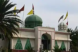 A mosque rebuilt more recently next to the dargah of Shah Paran.