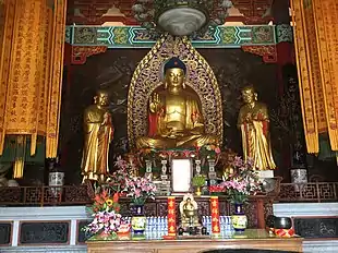 Buddha image, with images of two disciples at the sides.