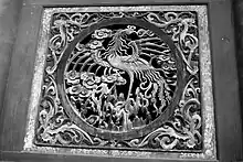 Image 57Relief of a fenghuang in Fuxi Temple (Tianshui). They are mythological birds of East Asia that reign over all other birds. (from Chinese culture)