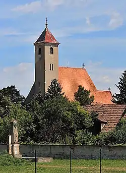 Saint Sigmund Roman Catholic Church and war memorial in Grinava