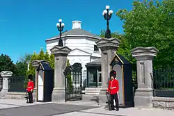 Two Governor General's Foot Guardsmen stand guard at the main entrance to the grounds of the monarch's and viceroy's residence, Rideau Hall, in Ottawa, 2012