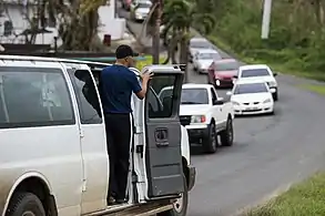 Volunteer distributing water after Hurricane Maria on Oct. 18, 2017