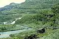 1961. Looking towards Grøna. The old path can be seen climbing upwards to cross Grøna above the waterfall. The new track meets the old at Grøna bridge and continues past Grønneseter (former dairy farm, now holiday cabin) and down the mountain side to Østerbø in Aurdalen.