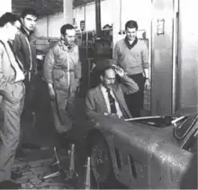 ASA head of operations Niccolò de Nora (kneeling) inspecting an ASAS 1000 GTC alongside staff.