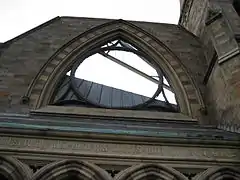 Charred rose window frame and facade