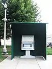 A touch screen kiosk in a green three-quarters tent