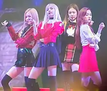 Blackpink performing "Playing with Fire" onstage