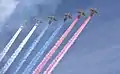 6 Sukhoi Su-25s displaying color smoke of the Russian Flag