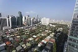 Bel-Air Village Phase 2 with skyscrapers most of which are also part of the barangay in the background