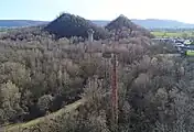 Perspective, chimney, two water towers and two slag heaps.