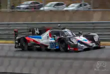 A grey, red and blue racing car