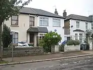 exterior of semi-detached house, with blue plaque on front wall