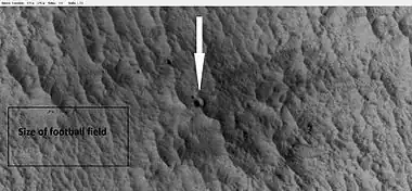 New crater, as seen by HiRISE under HiWish program.  The new crater indicated with the white arrow is about 10 yards across and was probably created by the collision with an object the size of a large watermelon.  This crater did not appear in earlier images of the same region.