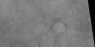 Ring of boulders around rim of old crater with dust devil tracks in the background, as seen by HiRISE under HiWish program