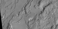 Fractures, as seen by HiRISE under HiWish program These fractures are believed to eventually turn into canyons because ice in the ground will disappear into the thin Martian atmosphere and the remaining dust will be blown away.