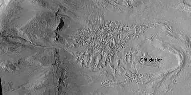 Glacier and gullies, as seen by HiRISE under HiWish program Some researchers suggest that gullies come after glaciers.  Location is Casius quadrangle.