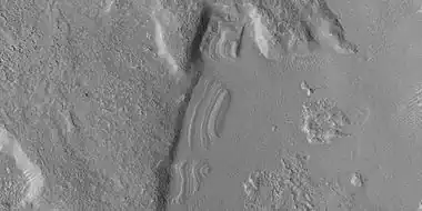 Close view of dipping layers along a mesa wall, as seen by HiRISE under HiWish program