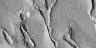 Close view of terrain caused by ice leaving the ground, as seen by HiRISE under HiWish program