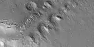 Close view of slopes that contain tilted layered features, as seen by HiRISE under HiWish program  Note: this is an enlargement from the previous image.