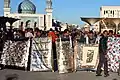 A protest outside the mosque, with the people flashing banners that indicate this protest is only for cultural and not religious purposes