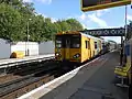 A Class 507 arrives with a service.