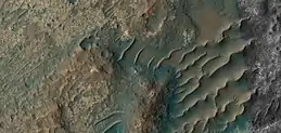 Close, color view of unusual transverse aeolian ridges, TAR's, as seen by HiRISE under HiWish program  These features may have had variable local winds to make the wavy tops.