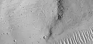 Grooves on wall of Kasei Valles, as seen by HiRISE under HiWish program  Grooves may be caused by water moving in the channel.