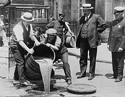 Image 15Prohibition agents emptying barrels of alcohol. (from 1920s)