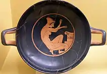 Woman kneeling before an altar. Attic red-figure kylix, 5th century BC