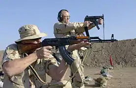 An Australian Air Traffic Control Detachment range officer fires an MP5K at the Baghdad International Airport firing range.