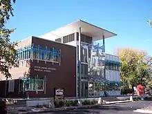 Entrance of attractive glass, steel and brick building on a sunny day in Canberra.