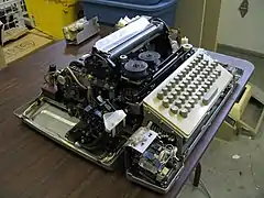 Paper tape punch and reader visible in foreground