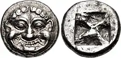 Ancient silver coin, showing a Gorgon's head on the obverse and a quadripartite incuse square on the reverse