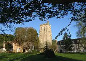 West side of the Tour Saint-Nicolas, between the ancient pottery to its left and the monks' residential building to its right