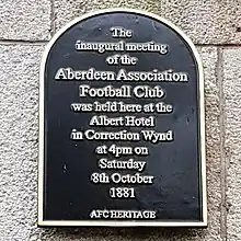 A black plaque with the text "the inaugural meeting of the Aberdeen Association Football Club was held here at the Albert Hotel in Correction Wynd, at 4pm on Saturday 8th October 1881. AFC Heritage"