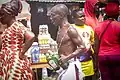 A man carrying schnapps to perform ritual during Aboakyer festival in Ghana