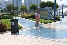 Street cleaner cleaning the pavement in Abu Dhabi, Middle East