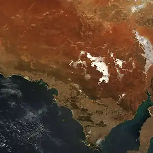 Orange and brown soils mix with off-white saltpans, including Lake Gairdner and Lake Everard in this true-colour image.