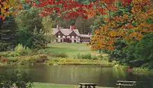 The Allegany State Park Administration Building as seen from the Red House Picnic Area across Red House Lake.