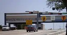 Gantry building with lanes labeled for full-service, exact change, and electronic tolling