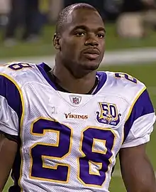 Adrian Peterson wearing his Vikings football uniform, but no helmet.