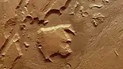 The large block in this image was separated from the nearby elevated areas by tectonic activity in Mars' past.