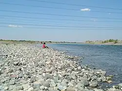 Part of Agno River flowing near Barangay San Vicente, Santa Maria Pangasinan.  A faint image of Narciso Ramos Bridge can be seen at a distance.