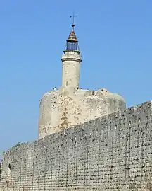 Putlog holes for hoardings are visible running along the top of the wall at Aigues-Mortes, France.