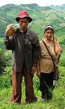 two humans standing in grass