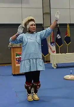 Alaska Native dancer performing in a kuspuk